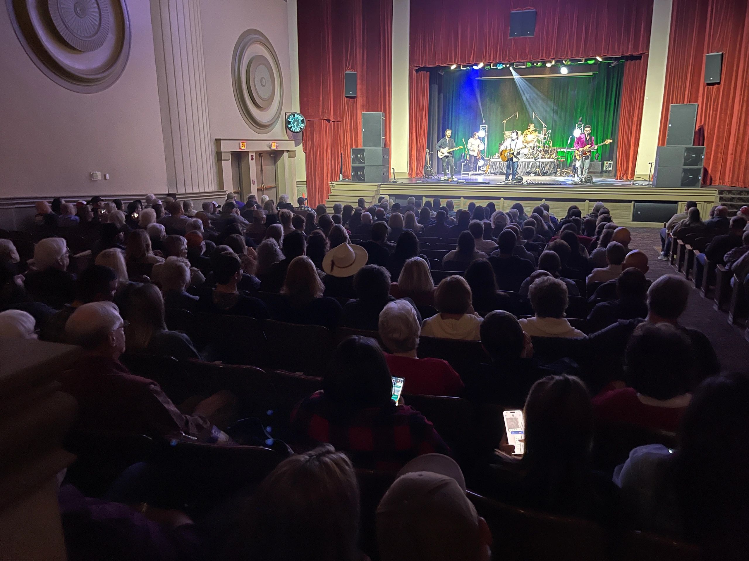 Concert with red curtains and stage lighting