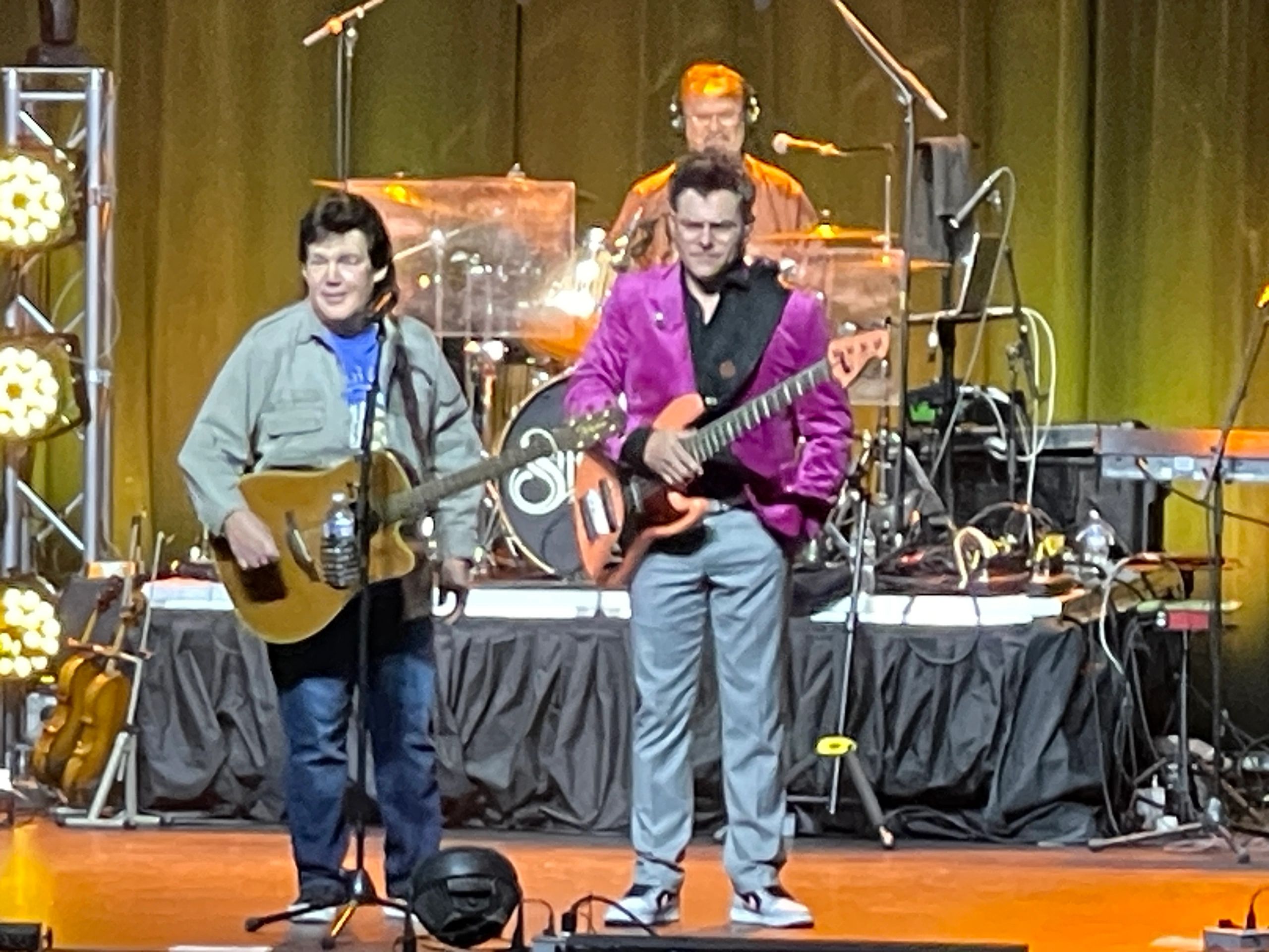 Band with guitarist in purple jacket